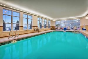 a swimming pool with blue water in a building at Hampton Inn & Suites Orem/Provo in Orem