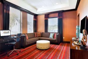 a living room with a couch and a desk at Hampton Inn Lewiston-Auburn in Lewiston