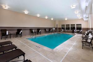 una piscina en una habitación de hotel con sillas alrededor en Hampton Inn Lewiston-Auburn, en Lewiston