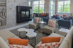 a living room with couches and a fireplace at Hilton Garden Inn Freeport Downtown in Freeport