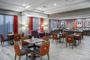 a restaurant with tables and chairs and a bar at Hampton Inn by Hilton Oxford, ME in Oxford
