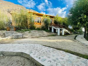 a house with a stone path in front of it at Thiksay Organic Resort in Ranbirpura