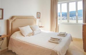 ein Schlafzimmer mit einem Bett mit Handtüchern darauf in der Unterkunft 4 Bedroom Amazing Apartment In Muros in Muros