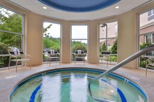 a hot tub in a room with windows at Hampton Inn & Suites by Hilton Plymouth in Plymouth