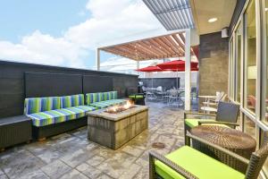 a patio with a couch and a fire pit at Home2 Suites By Hilton Rapid City in Rapid City