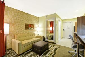 a living room with a couch and a desk at Home2 Suites By Hilton Rapid City in Rapid City