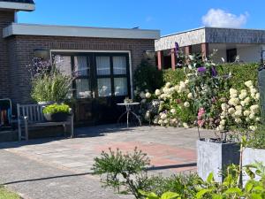 eine Terrasse mit Blumen vor einem Gebäude in der Unterkunft Flowerbed in Voorhout
