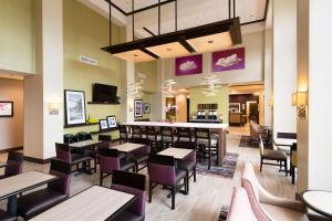 a restaurant with tables and chairs and a bar at Hampton Inn & Suites Walterboro in Walterboro