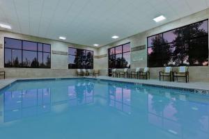 a swimming pool with blue water in a building at Hampton Inn & Suites Bend in Bend