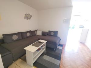 a living room with a couch and a coffee table at Apartmani Rudelj in Makarska