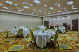 a banquet room with tables and chairs with white tablecloths at Hampton Inn & Suites Bend in Bend +31 photos