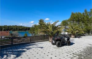 a four wheeler parked on a brick patio next to a lake at Villa Bella in Mrljane +32 photos