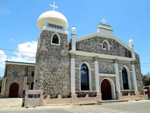a church with a cross on top of it at La Minimalista in Bagac
