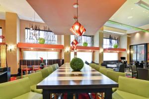 a dining room with a large table and chairs at Hampton Inn & Suites Crabtree in Raleigh