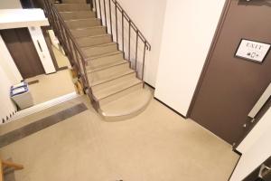 an empty hallway with stairs in a building at The Hotel Saint-Felicien Kyoto Shijo Karasuma in Kyoto
