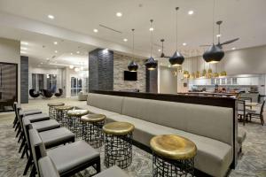 a lobby with a row of stools and a bar at Homewood Suites by Hilton Raleigh Cary I-40 in Cary