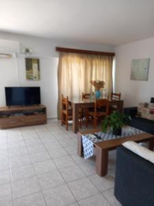 a living room with a couch and a table at Galini Apartments in Plakias