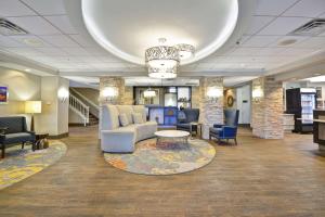a lobby with a couch and a table and chairs at Homewood Suites Durham-Chapel Hill I-40 in Durham