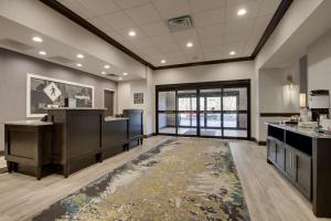 a large room with a salon with a rug at Hampton Inn & Suites By Hilton Knightdale Raleigh in Raleigh