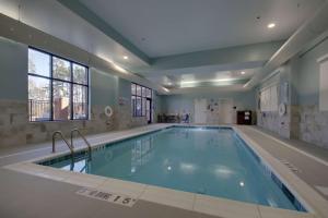 a large swimming pool in a building at Hampton Inn & Suites By Hilton Knightdale Raleigh in Raleigh
