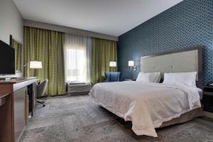 a hotel room with a bed and a television at Hampton Inn & Suites By Hilton Knightdale Raleigh in Raleigh