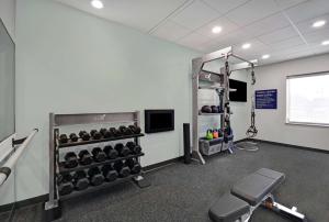 a gym with a rack of dumbbells at Tru By Hilton Burlington in Burlington