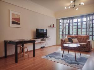 a living room with a table and a couch at 7pax-Genting Premium Outlet LARGEST Family Retro English Cottage - F-Parking, Self C-In in Genting Highlands