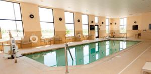 瑞佛頓的住宿－里弗頓漢普頓套房酒店，一座大型游泳池,位于一座带窗户的建筑内