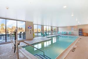a large indoor pool with blue water in a building at Home2 Suites By Hilton Raleigh Durham Airport RTP in Durham