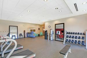 a gym with treadmills and exercise equipment in a room at Home2 Suites By Hilton Raleigh Durham Airport RTP in Durham