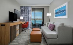 a living room with a couch and a tv at Hampton Inn & Suites Reno/Sparks in Reno