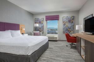 a hotel room with a bed and a flat screen tv at Hampton Inn & Suites Reno/Sparks in Reno