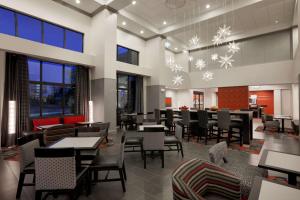 a restaurant with tables and chairs and snow at Hampton Inn and Suites Roanoke Airport/Valley View Mall in Roanoke