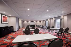 a conference room with tables and chairs and a screen at Hampton Inn and Suites Roanoke Airport/Valley View Mall in Roanoke +30 photos