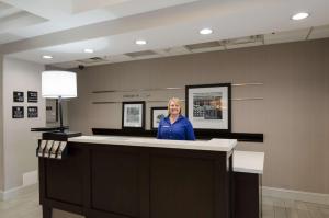 a woman standing at a counter in a salon at Hampton Inn Salem in Salem