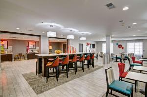a lobby with a cafeteria with tables and chairs at Hampton Inn Salem in Salem