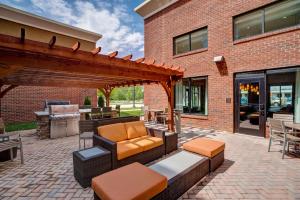 a patio with a couch and a pergola at Homewood Suites by Hilton Christiansburg in Christiansburg