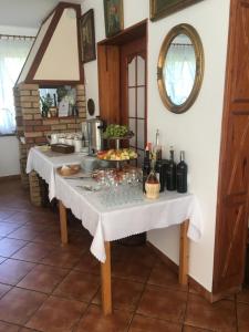 a kitchen with a table with bottles and glasses on it at Pensjonat u Alexa in Załuski