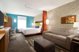 a hotel room with a bed and a couch at Home2 Suites by Hilton Roanoke in Roanoke
