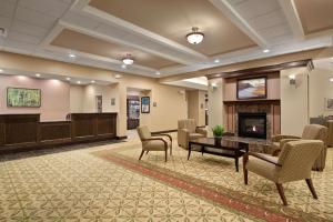 a lobby with a waiting room and a fireplace at Homewood Suites by Hilton Rochester - Victor in Victor