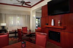 a hotel room with a dining area with a television and a living room at Hampton Inn & Suites Roswell in Roswell