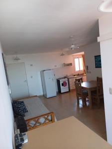 a small kitchen with a table and a refrigerator at tu lugar 2 in Córdoba