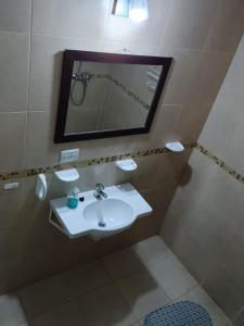 a bathroom with a sink and a mirror at tu lugar 2 in Córdoba