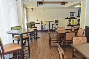 a waiting room with tables and chairs in a restaurant at Hampton Inn Ruston in Ruston