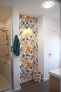 a bathroom with a shower and a wall mural at Maison Coté Jardin Amiens - Longueau in Longueau