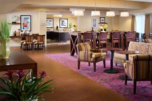 a lobby of a hotel with chairs and a bar at Hampton Inn San Diego/Del Mar in San Diego