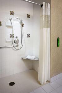 a shower with a shower curtain in a bathroom at Hampton Inn San Diego/Del Mar in San Diego