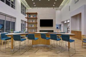 a conference room with a table and chairs and a tv at Homewood Suites By Hilton Chula Vista Eastlake in Chula Vista