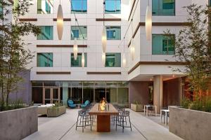 a view of a building with a table and chairs at Hilton Garden Inn San Diego Downtown/Bayside, CA in San Diego