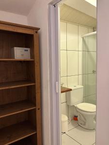 a bathroom with a toilet and a glass shower at Pousada Sambaki in Paraty